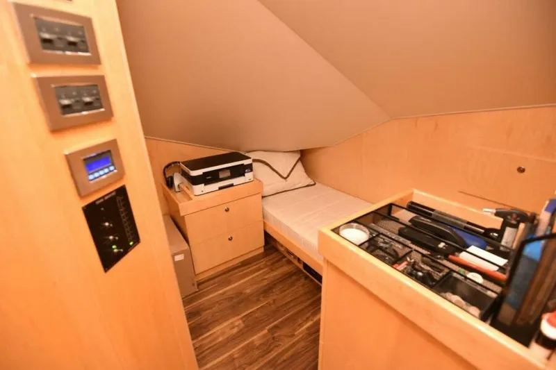 Slide: The Image of Cozy cabin interior of 2017 Viking 80 Sky Bridge yacht with bed and storage. - 36