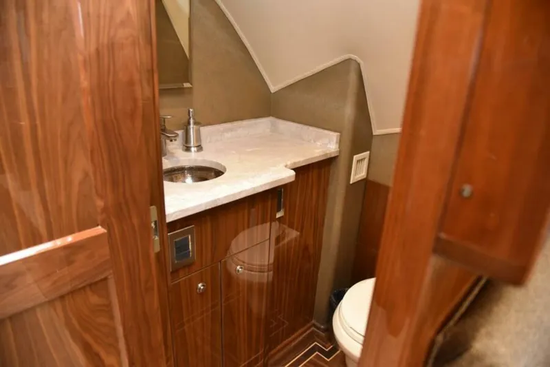 Slide: The Image of Luxurious bathroom interior of 2017 Viking 80 Sky Bridge yacht with wood finish. - 37