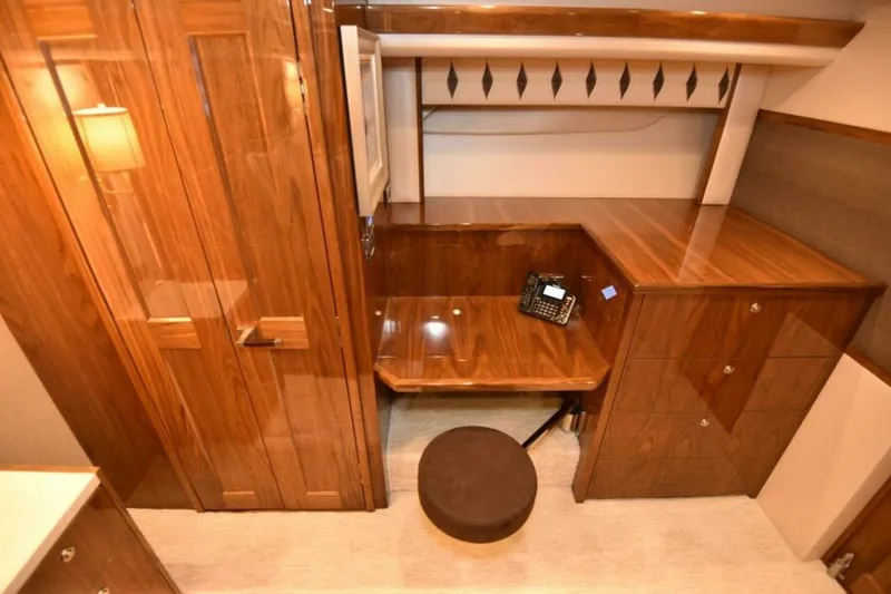 Slide: The Image of Luxurious wooden interior of 2017 Viking 80 Sky Bridge yacht with desk and phone. - 42