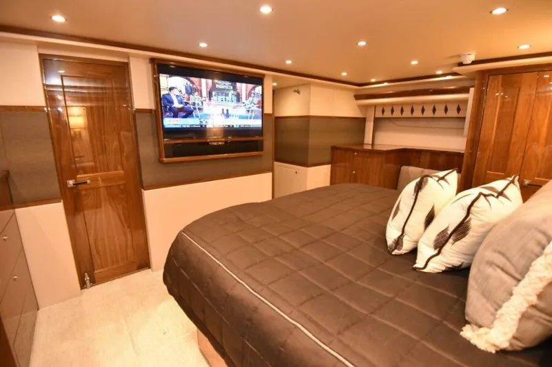 Slide: The Image of Luxurious bedroom interior of 2017 Viking 80 Sky Bridge yacht with TV and elegant decor. - 43