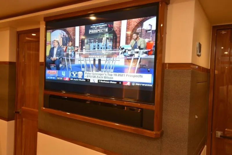 Slide: The Image of Luxurious interior of 2017 Viking 80 Sky Bridge yacht with TV displaying sports program. - 44