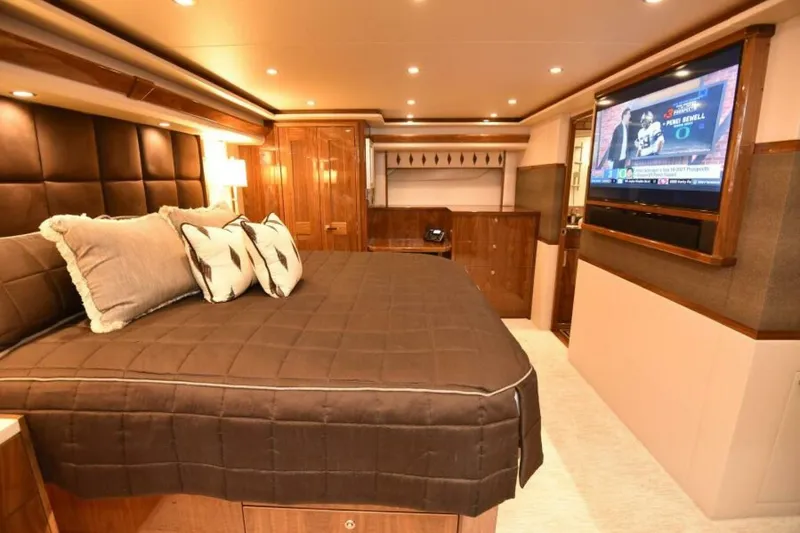 Slide: The Image of Luxurious bedroom interior of 2017 Viking 80 Sky Bridge yacht with TV and elegant decor. - 45