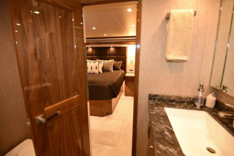 Slide: The Image of Luxurious interior of 2017 Viking 80 Sky Bridge yacht, featuring elegant bedroom and bathroom. - 47