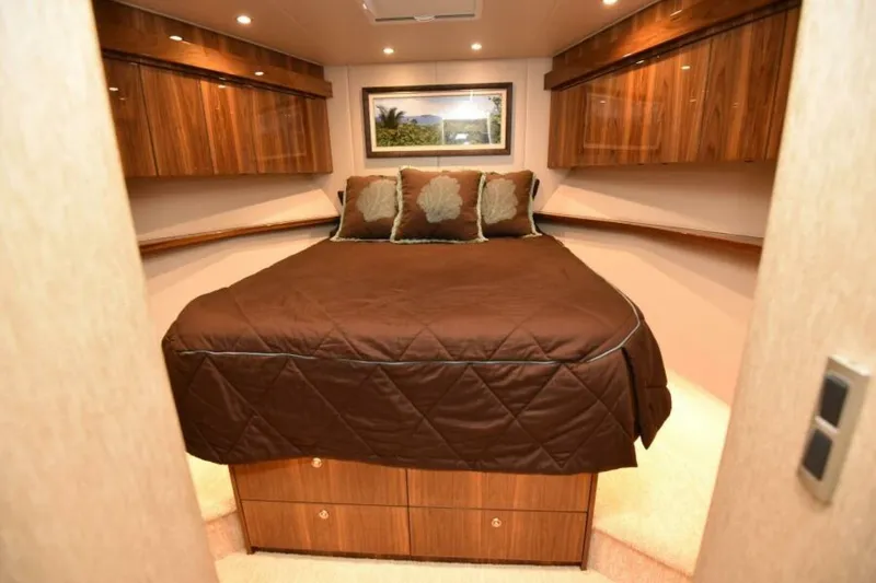 Slide: The Image of Luxurious bedroom interior of 2017 Viking 80 Sky Bridge yacht with wood cabinetry. - 53