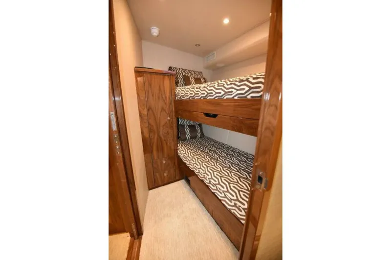 Slide: The Image of Bunk beds in 2017 Viking 80 Sky Bridge yacht cabin with patterned bedding. - 59