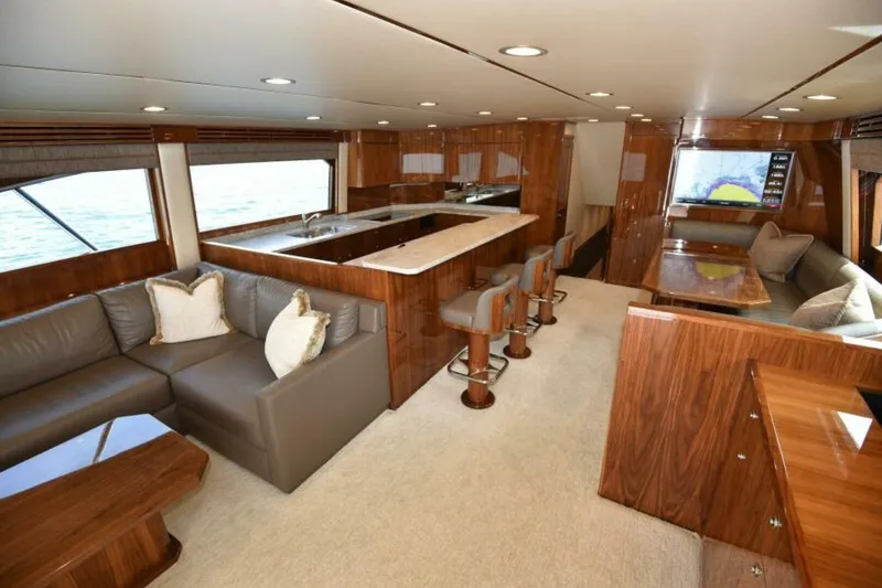 Slide: The Image of Luxurious interior of 2017 Viking 80 Sky Bridge yacht with elegant seating and dining area. - 6