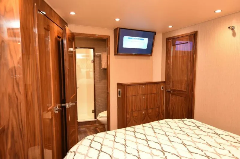 Slide: The Image of Luxurious cabin interior of 2017 Viking 80 Sky Bridge yacht with wood finishes. - 69