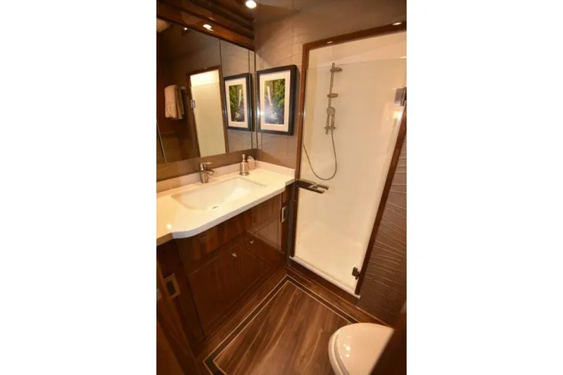 Slide: The Image of Luxurious bathroom in 2017 Viking 80 Sky Bridge yacht with modern fixtures and elegant design. - 70