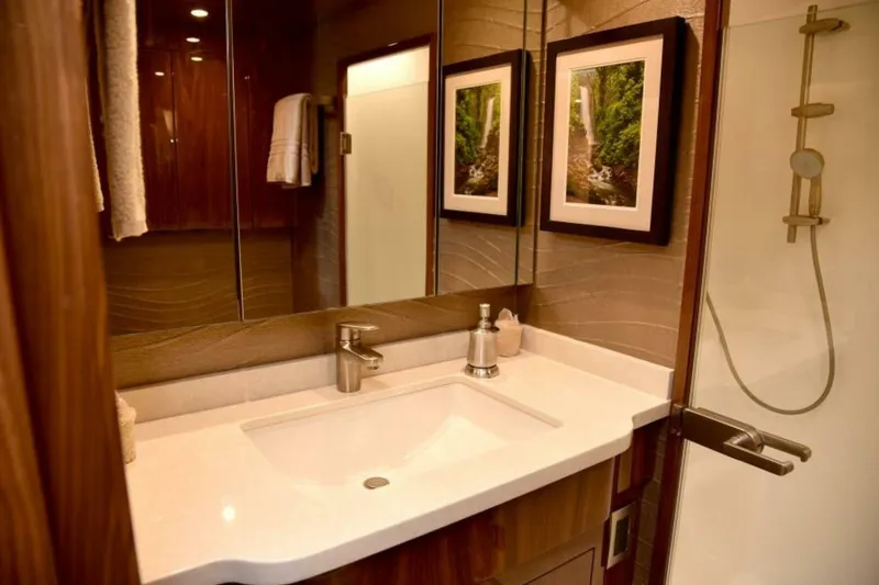 Slide: The Image of Luxurious bathroom in 2017 Viking 80 Sky Bridge yacht with modern fixtures and elegant decor. - 72