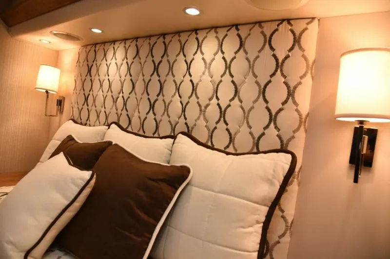 Slide: The Image of Luxurious bedroom interior of 2017 Viking 80 Sky Bridge yacht with elegant lighting and cushions. - 77