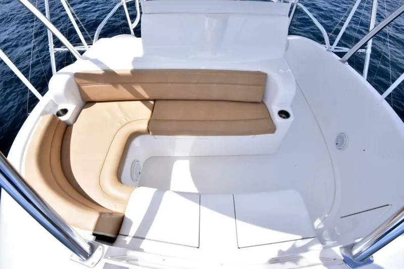 Slide: The Image of 2017 Viking 80 Sky Bridge yacht with tan seating and ocean view. - 79