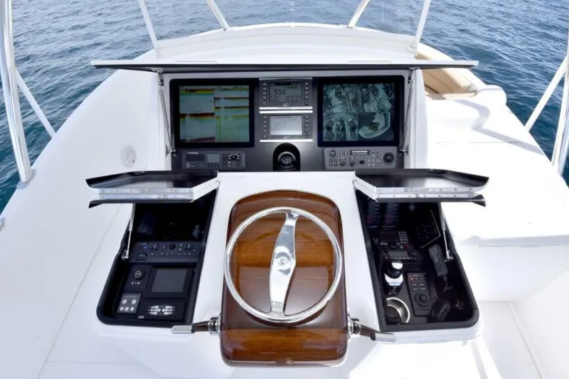 Slide: The Image of 2017 Viking 80 Sky Bridge helm with advanced navigation and control systems. - 80