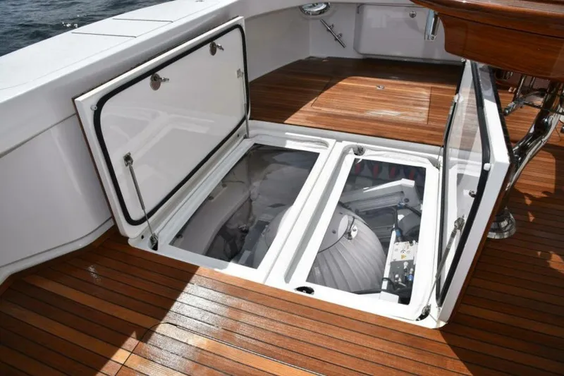 Slide: The Image of Open storage compartment on 2017 Viking 80 Sky Bridge yacht with wooden deck. - 82