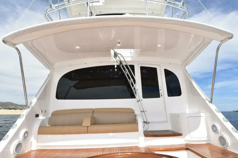Slide: The Image of 2017 Viking 80 Sky Bridge yacht with spacious deck and seating area. - 84
