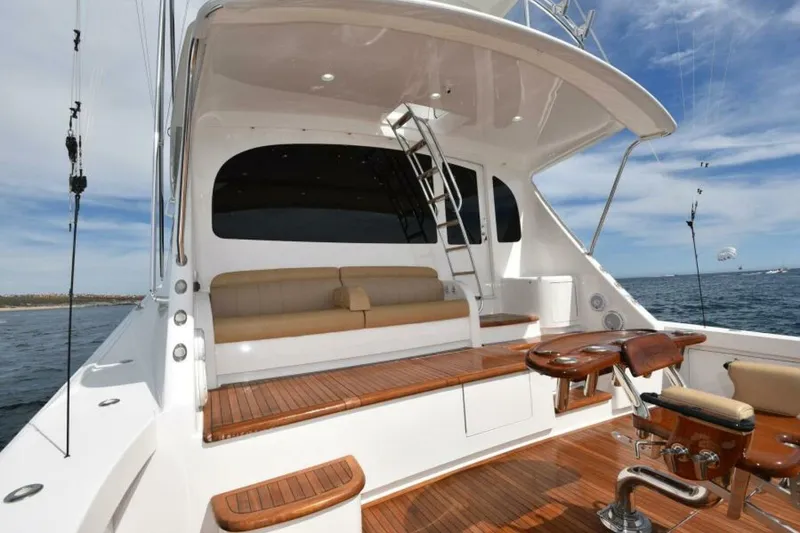 Slide: The Image of 2017 Viking 80 Sky Bridge yacht with wooden deck and seating, ocean view. - 85