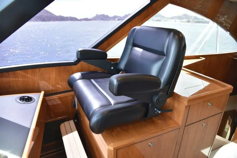 Slide: The Image of Luxurious captain's chair on 2017 Viking 80 Sky Bridge yacht, overlooking ocean view. - 9