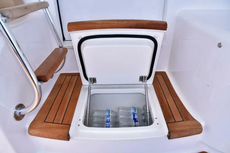 Slide: The Image of Built-in cooler with water bottles on 2017 Viking 80 Sky Bridge yacht. - 92