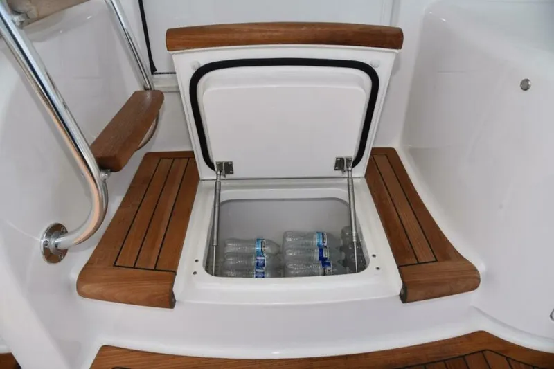 Slide: The Image of Built-in cooler with water bottles on 2017 Viking 80 Sky Bridge yacht. - 94