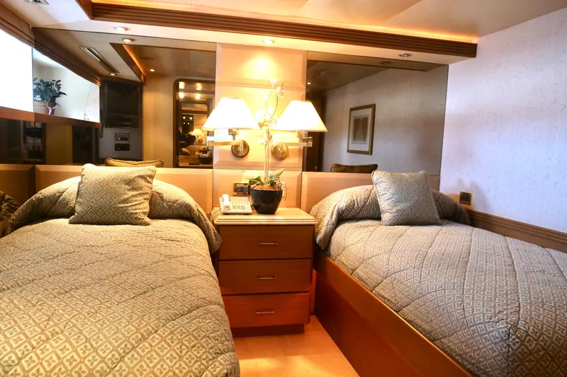 Slide: The Image of Luxurious twin bedroom on 2000 Westport 112 yacht, featuring elegant decor and ambient lighting. - 14