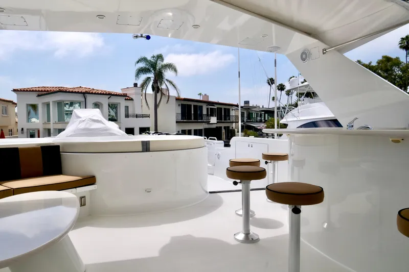 Slide: The Image of Luxurious 2000 Westport 112 yacht deck with bar stools and scenic waterfront view. - 28