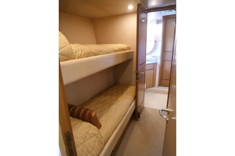Slide: The Image of Bunk beds in a 2000 Westport 112 yacht cabin with beige decor. - 38