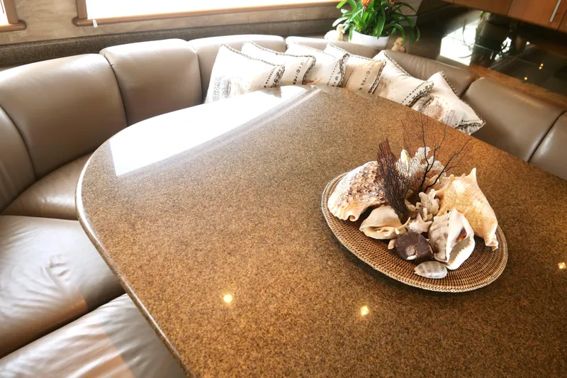 Slide: The Image of Luxurious Westport 112 yacht interior with elegant table, seashell decor, and plush seating, 2000 model. - 80