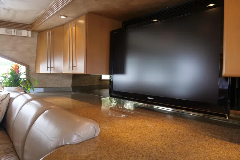 Slide: The Image of Luxurious Westport 112 yacht interior with TV, leather seating, and elegant cabinetry, 2000 model. - 85