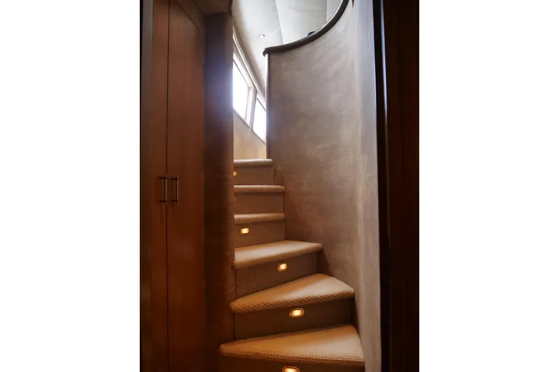 Slide: The Image of Curved staircase with carpet and lighting on a 2000 Westport 112 yacht. - 89