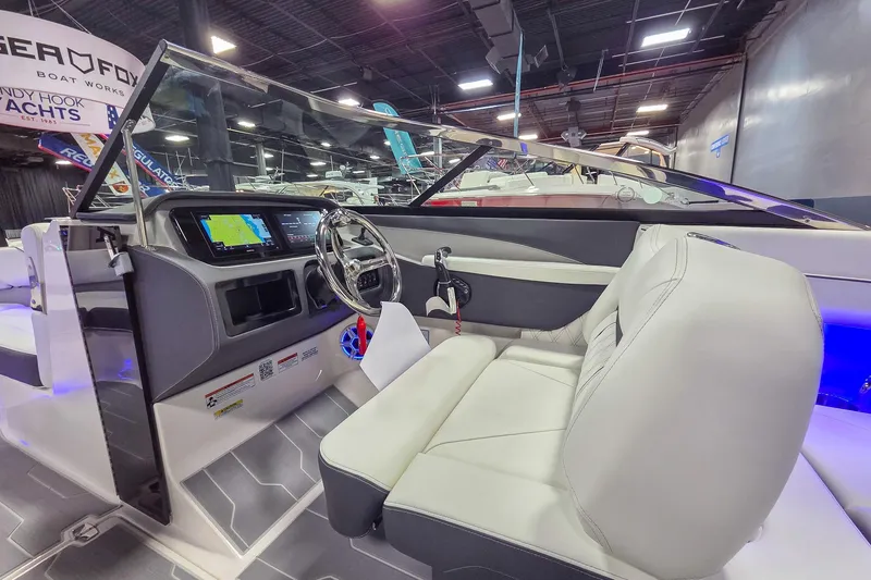 Slide: The Image of Interior view of 2026 Regal LX6 boat with modern dashboard and seating. - 11