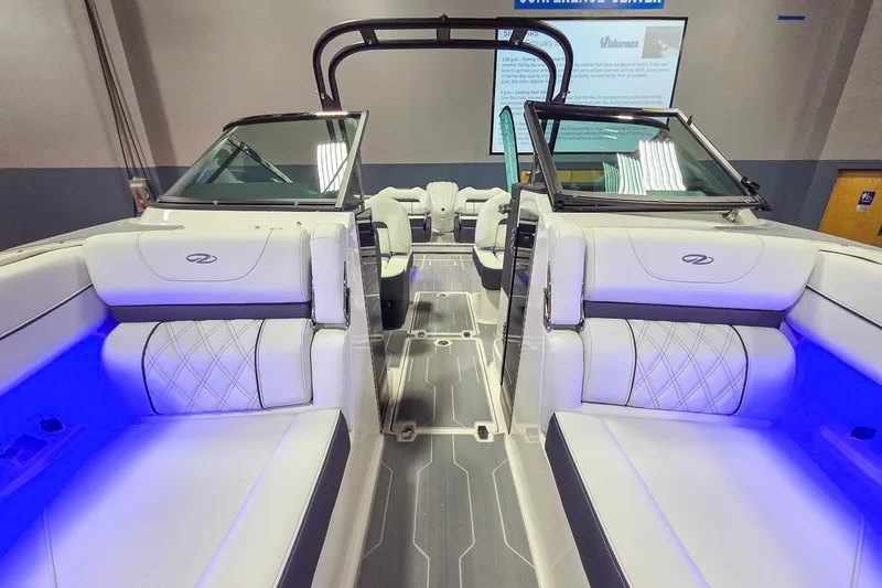 Slide: The Image of 2026 Regal LX6 boat interior with luxurious white seating and ambient blue lighting. - 18