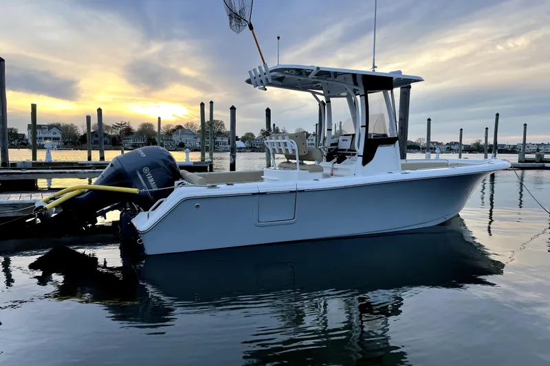 The Image of 2017 Sea Hunt Ultra 235 SE boat docked at sunset, calm waters, scenic background. - 0