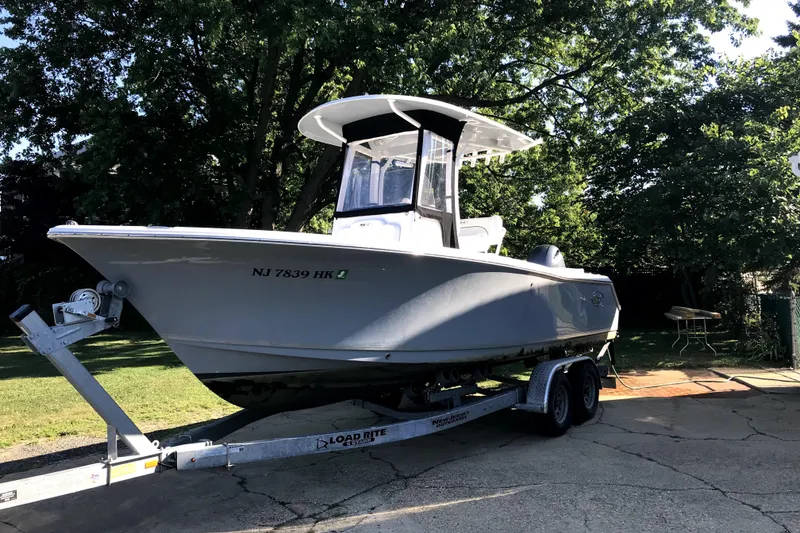 Slide: The Image of 2017 Sea Hunt Ultra 235 SE boat on trailer, parked outdoors. - 10
