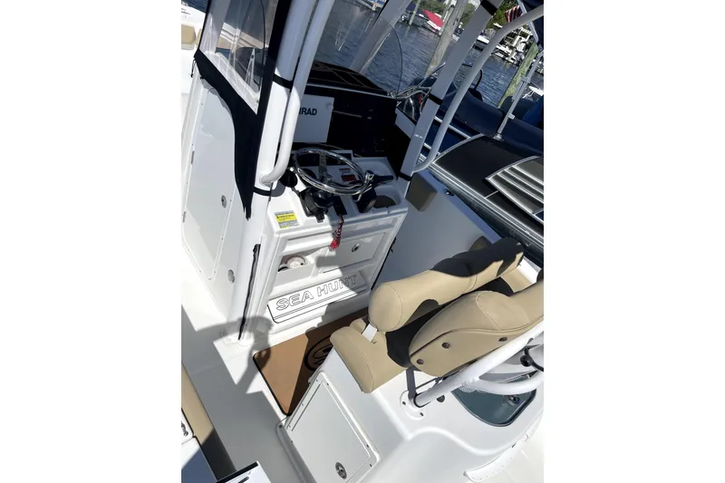 Slide: The Image of 2017 Sea Hunt Ultra 235 SE boat interior with steering wheel and seating. - 4