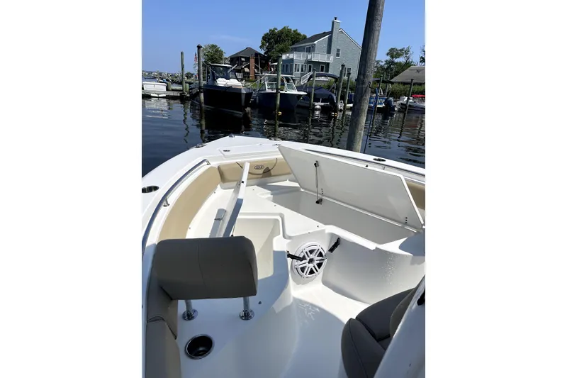 Slide: The Image of 2017 Sea Hunt Ultra 235 SE boat interior at a marina dock. - 6