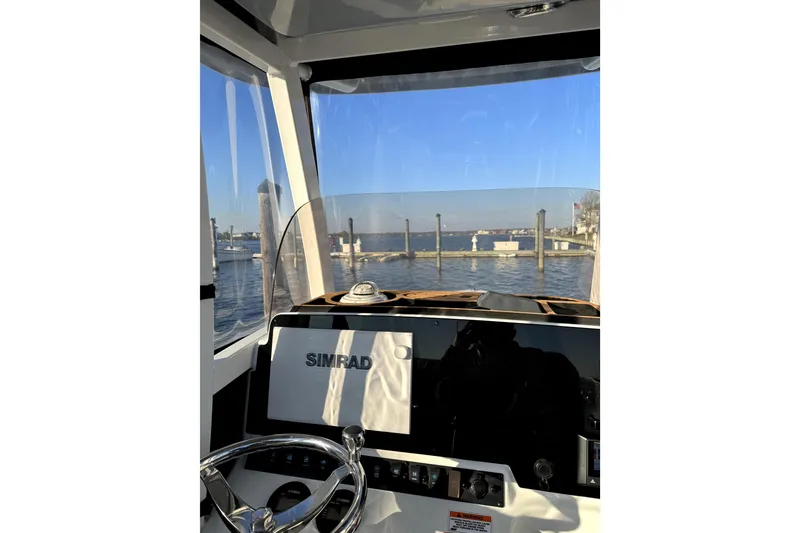 Slide: The Image of Interior view of 2017 Sea Hunt Ultra 235 SE boat with Simrad navigation system. - 8