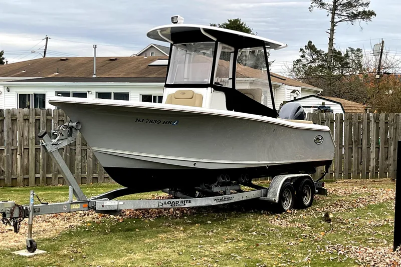 Slide: The Image of 2017 Sea Hunt Ultra 235 SE boat on trailer in residential yard. - 9