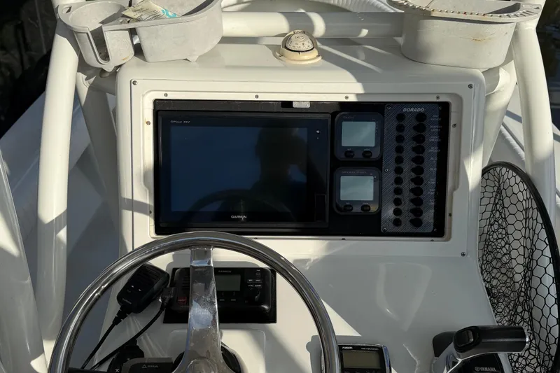 Slide: The Image of Control panel of a 2016 Dorado 23 boat with Garmin GPS and steering wheel. - 12