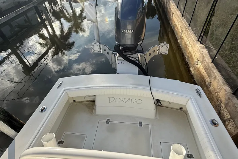 Slide: The Image of 2016 Dorado 23 boat with Yamaha 200 engine docked by a canal. - 13