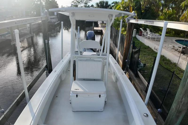 Slide: The Image of 2016 Dorado 23 boat docked, featuring a Yeti cooler and serene waterfront setting. - 15