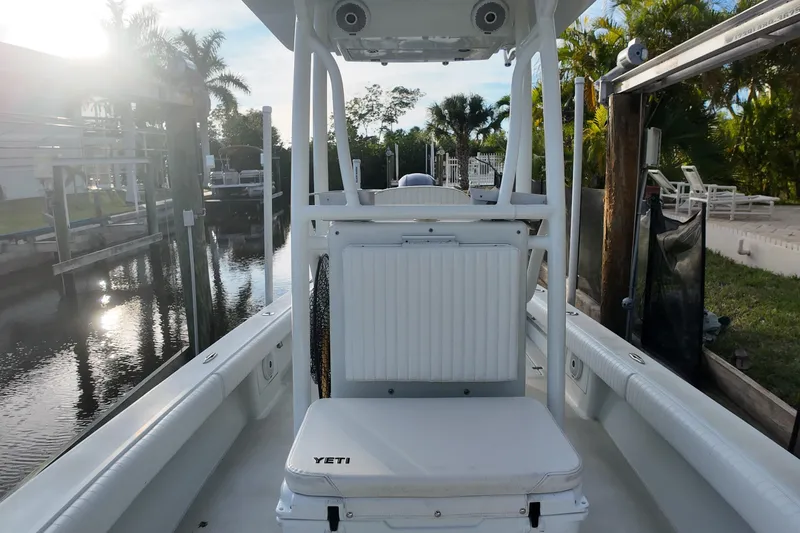 Slide: The Image of 2016 Dorado 23 boat interior with Yeti cooler, docked by a canal. - 16