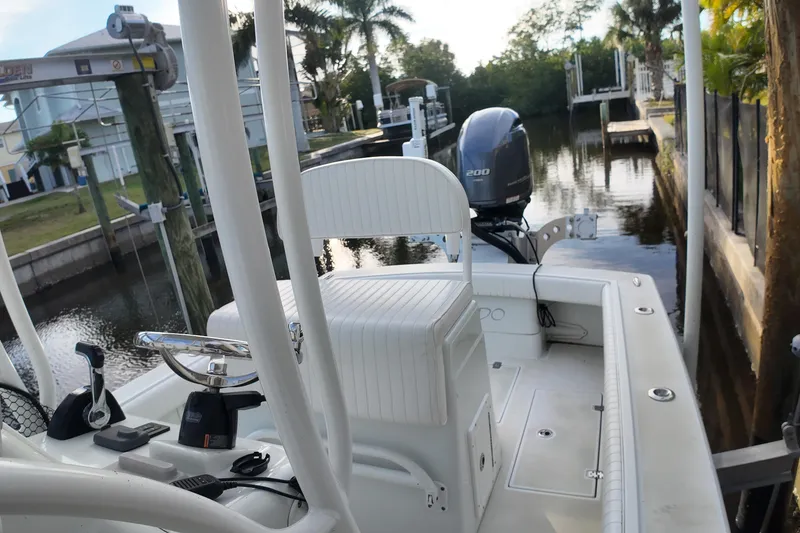 Slide: The Image of 2016 Dorado 23 boat docked by a canal, featuring a 200 horsepower engine. - 17