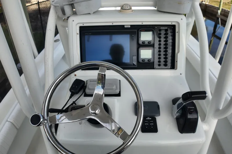 Slide: The Image of 2016 Dorado 23 boat dashboard with steering wheel and navigation controls. - 19