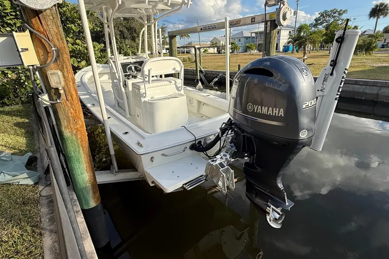 Slide: The Image of Boat cruising near lush island with buildings in background, Dorado 23, 2016 model. - 2