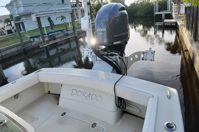 Slide: The Image of 2016 Dorado 23 boat with Yamaha 200 engine docked by a canal. - 21
