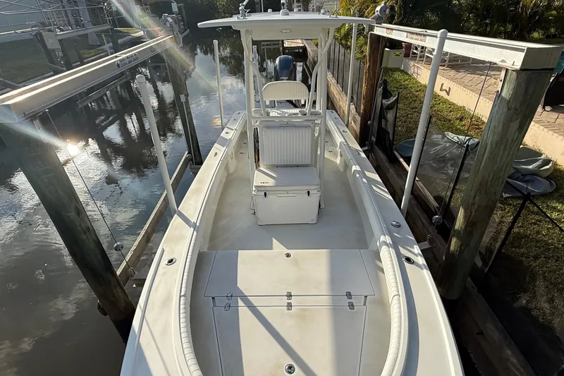 Slide: The Image of 2016 Dorado 23 boat cruising on a calm river with three passengers. - 3