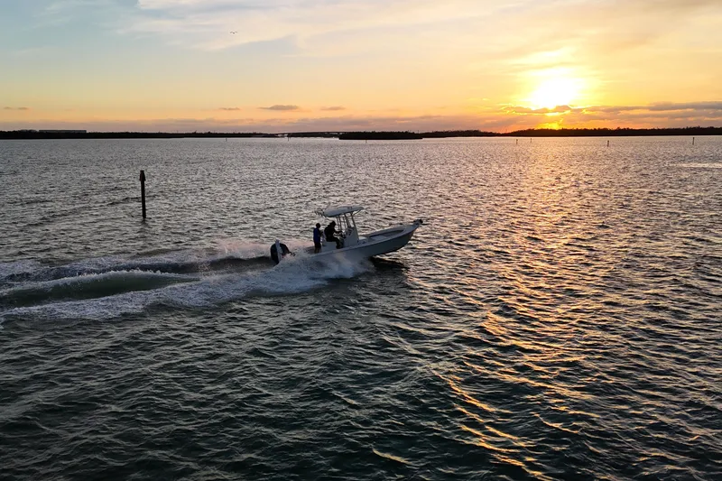 Slide: The Image of Dorado 23 boat cruising at sunset on open water, 2016 model. - 33