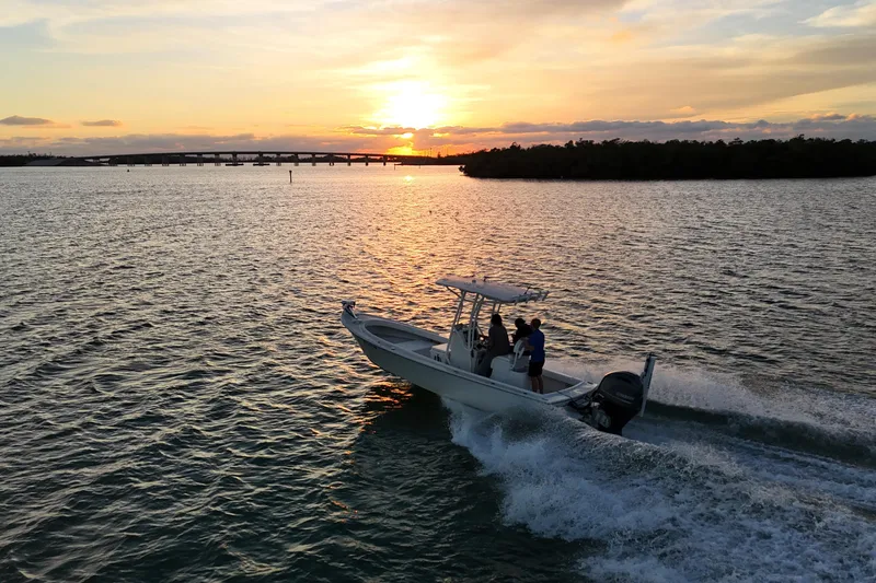 Slide: The Image of 2016 Dorado 23 boat cruising at sunset on a serene waterway. - 34