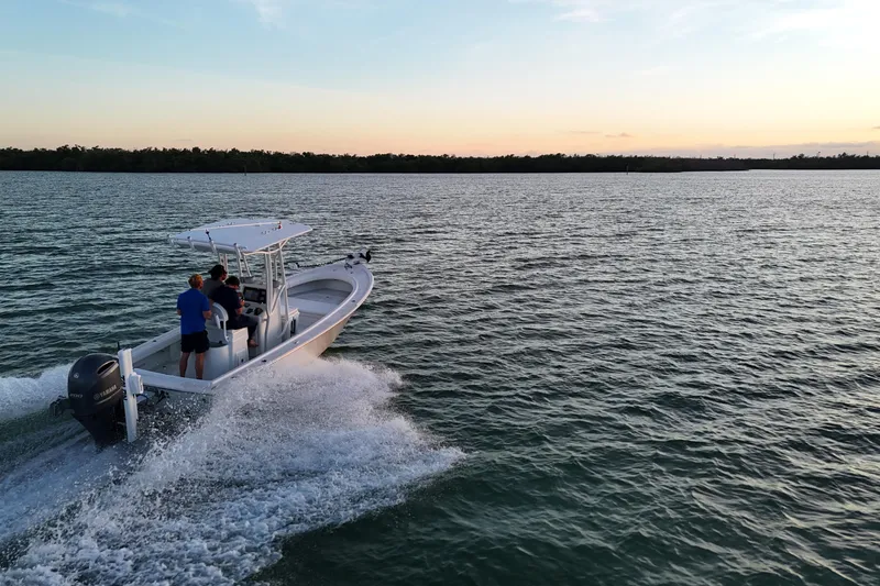 Slide: The Image of 2016 Dorado 23 boat cruising on open water at sunset. - 35