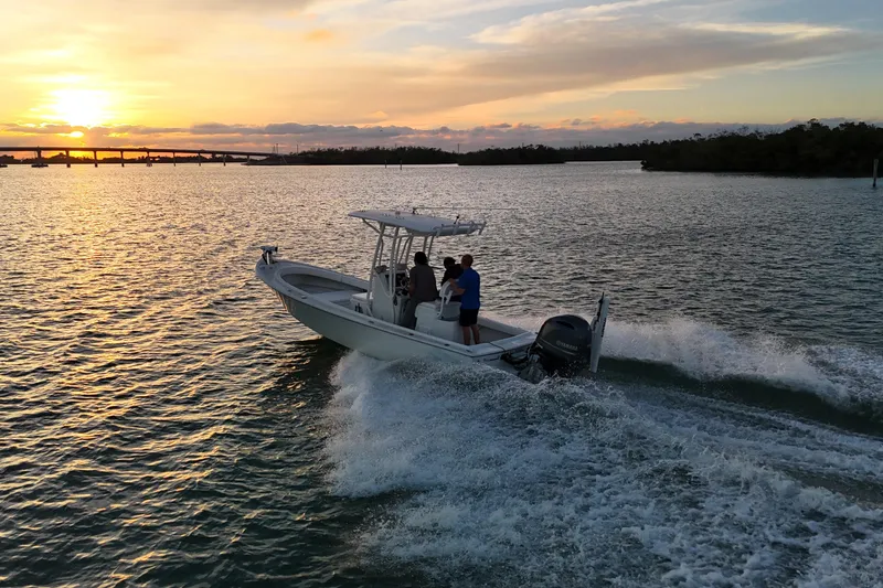 Slide: The Image of 2016 Dorado 23 boat cruising at sunset on a scenic waterway. - 36