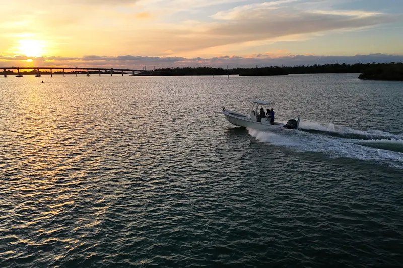 Slide: The Image of 2016 Dorado 23 boat cruising at sunset on a serene waterway. - 37